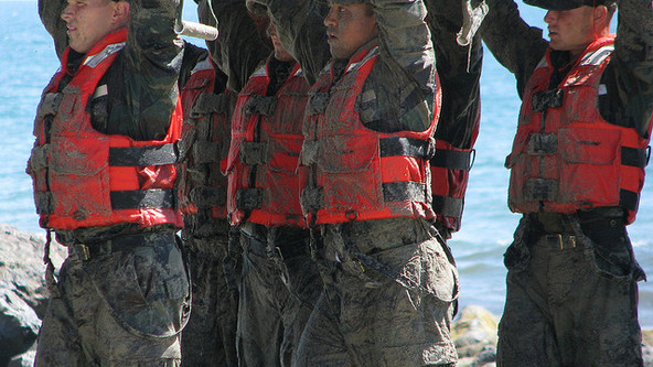 Navy Seal candidates all sandy and happy